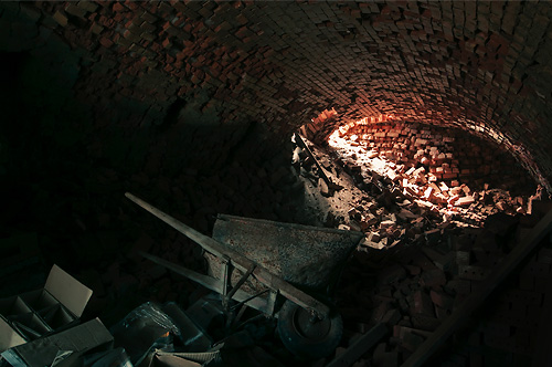 Brick oven interior with wheel barrel